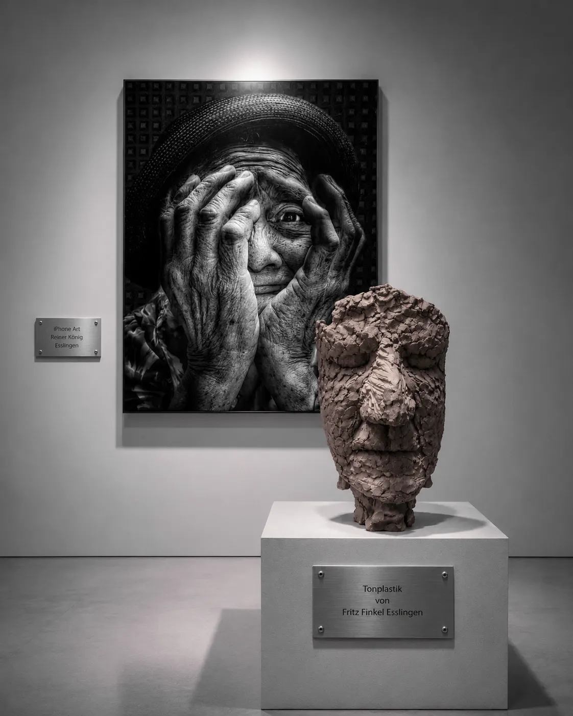Portrait photograph and clay sculpture displayed together