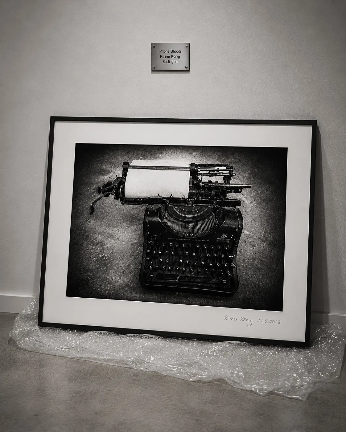 Framed black-and-white photograph of an old typewriter
